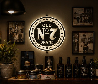 The illuminated Jack Daniel's Old No. 7 sign above a shelf of beard oils and pomades